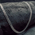 Silver chain on a textured dark surface